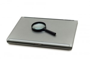 Laptop and Magnifying Glass 