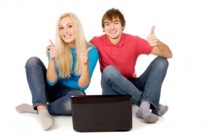 Be ethical and communicate well to improve your relationships Happy couple giving the thumbs up in front of a laptop computer