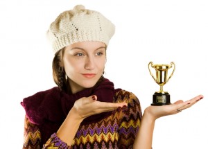 Observe, analyze, and grow to reap the rewards. Woman in hat with tiny trophy