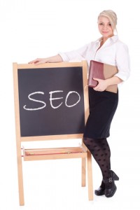 Businesswoman Standing Next to Chalkboard with SEO on It