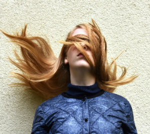 person blinded by flying hair