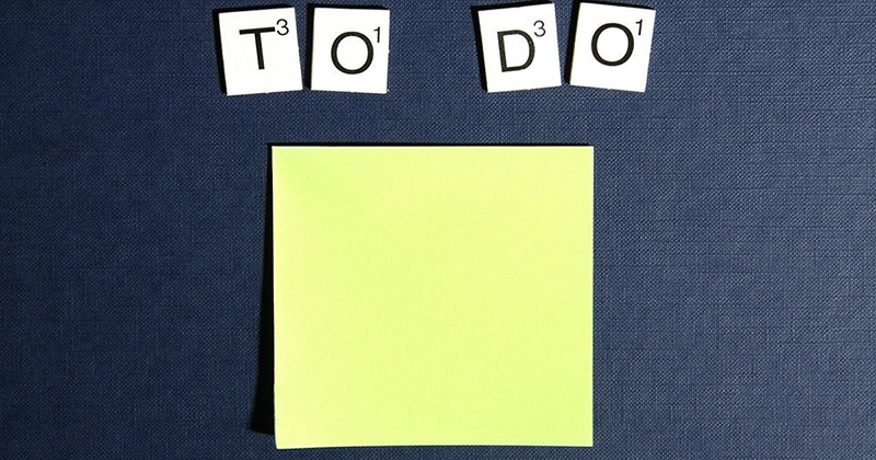 Yellow notepad with lettered tiles spelling "To Do."