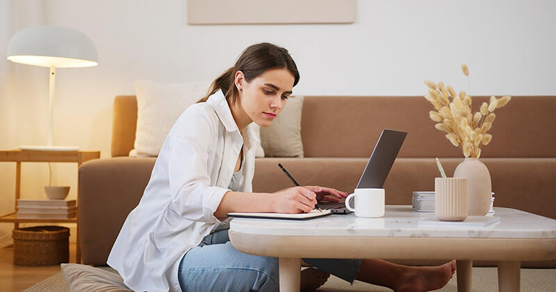 Woman taking notes learning about SEO.