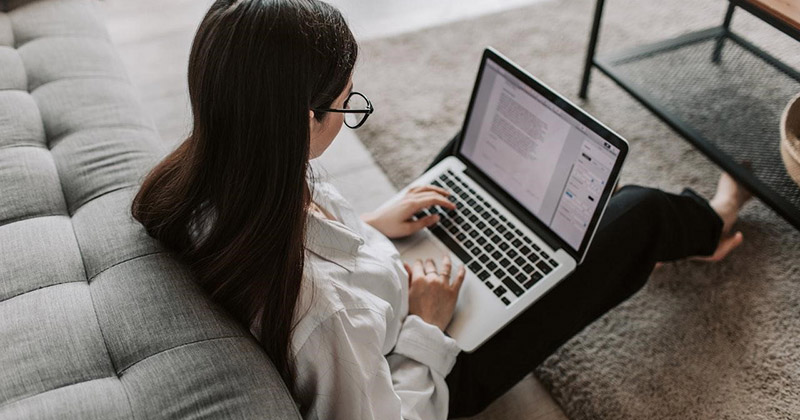 Woman optimizes website on a laptop.