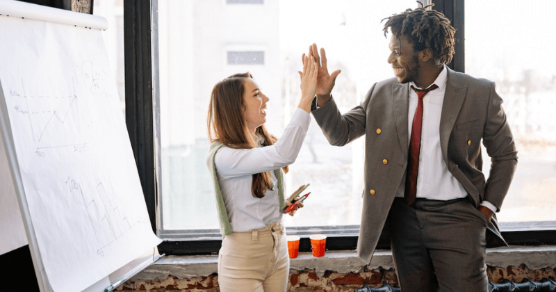 Two colleagues high fiving