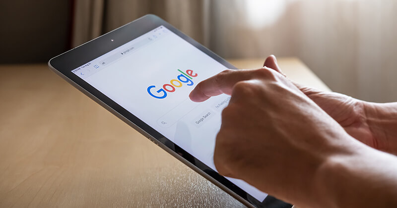 User executing a Google search on a tablet.