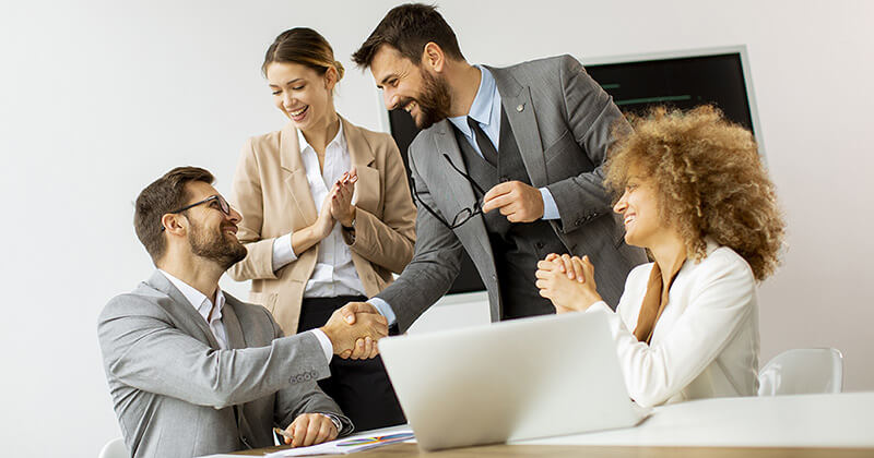 Business professionals shaking hands during a meeting.