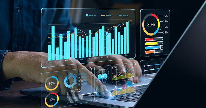 Professional reviewing data and analytics on laptop.