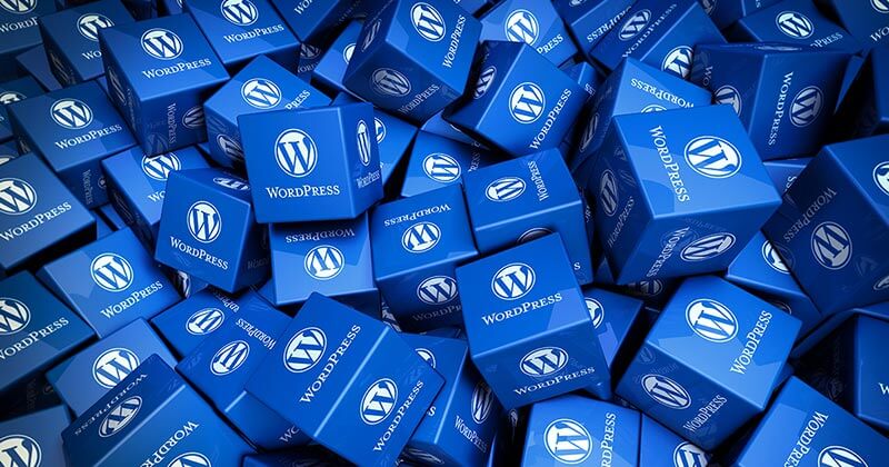 A bundle of cubes with WordPress logo printed on them.