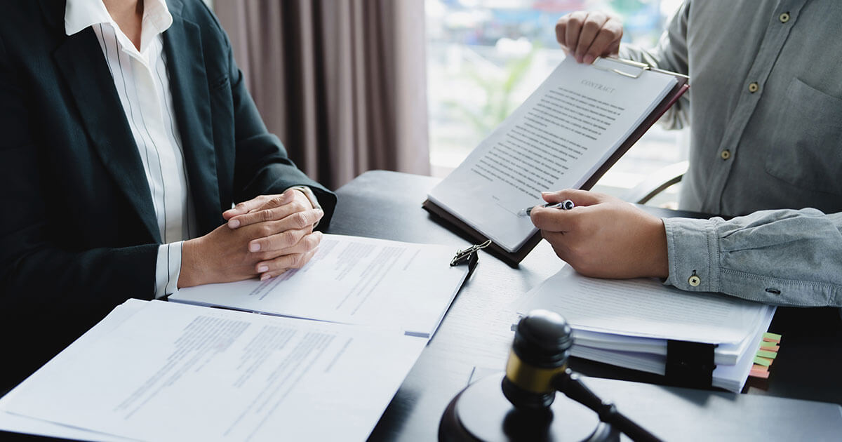 Employment lawyer showing document to client.