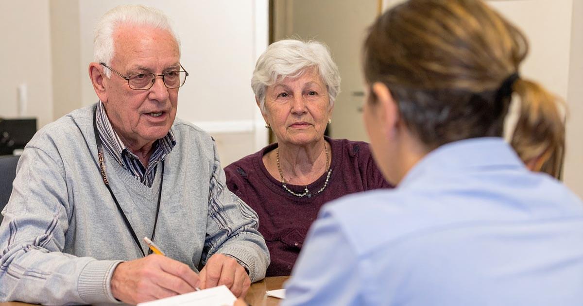 elderly couple meeting with estate planning lawyer.