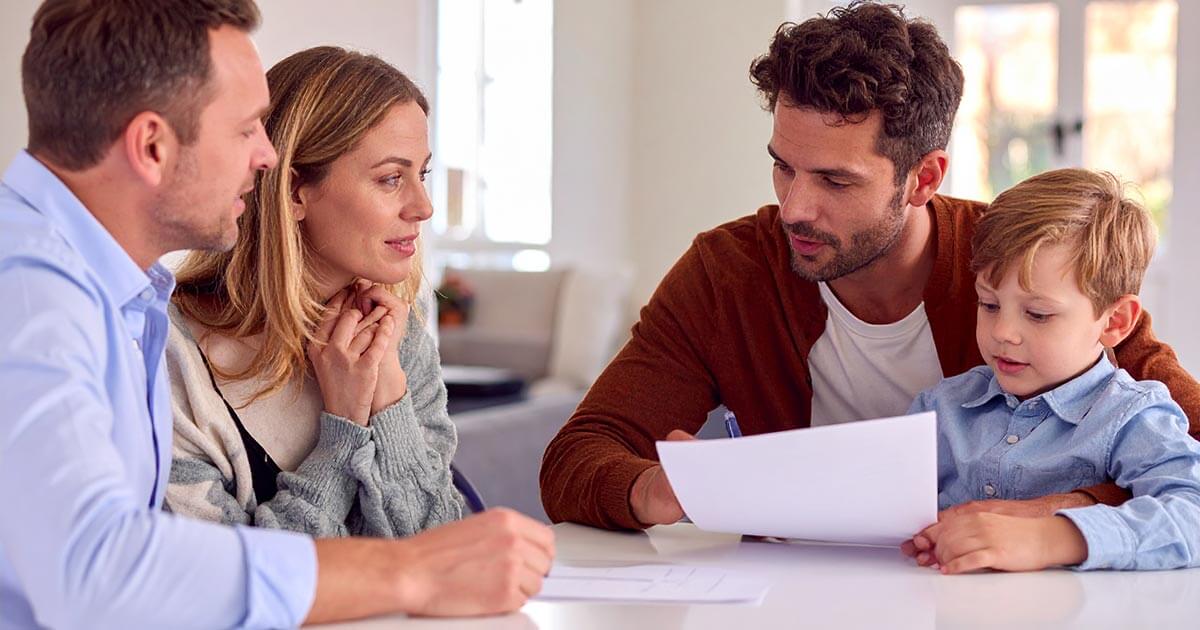 couple with young boy meeting with family law attorney.
