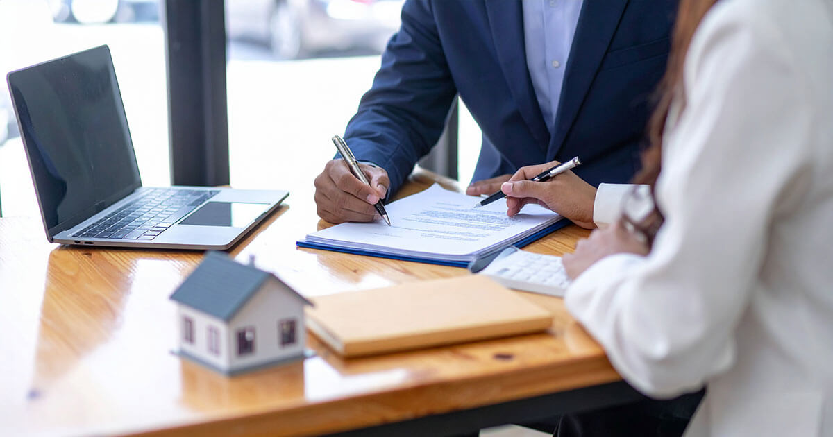 real estate attorney going over contract with client.