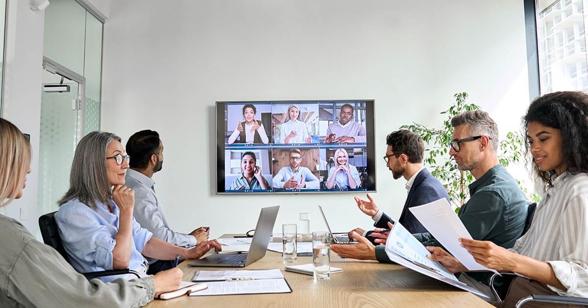 Clients meeting with agency in conference room reviewing their work.