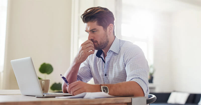 male professional working on laptop.