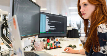 woman working on desktop computer.