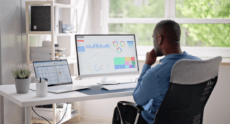 Professional reviewing SEO analytics dashboard with traffic charts, performance metrics, and reporting tools