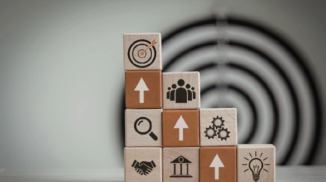 Stack of blocks with up arrows aligned and a target in the background