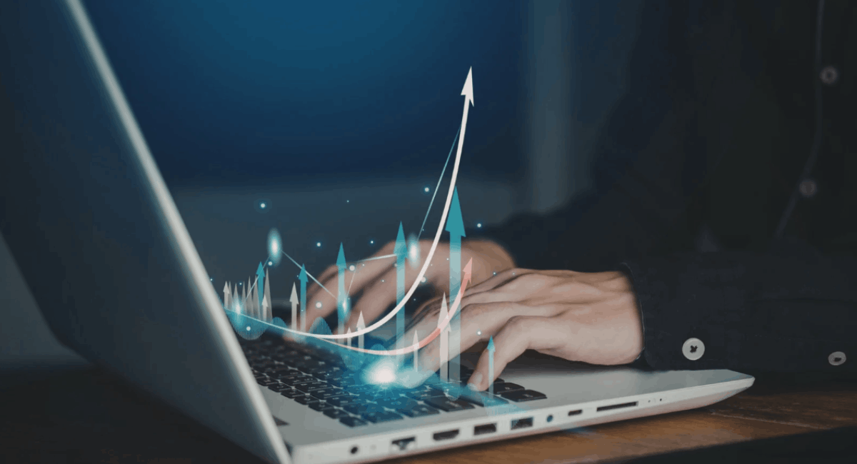 Close-up view of hands typing on a laptop keyboard with a glowing, digital 3D overlay of multiple growth arrows pointing upwards, symbolizing data analytics, success, or financial progression.